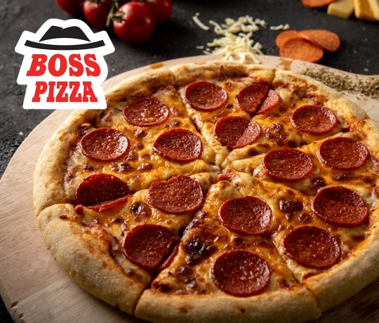 Wooden chopping board with a pepperoni pizza on top with boss pizza logo on it