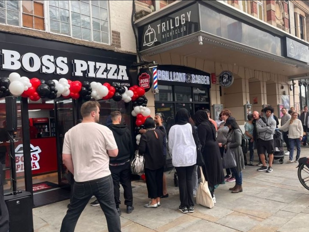 People queue out the door for new pizza spot on its opening day